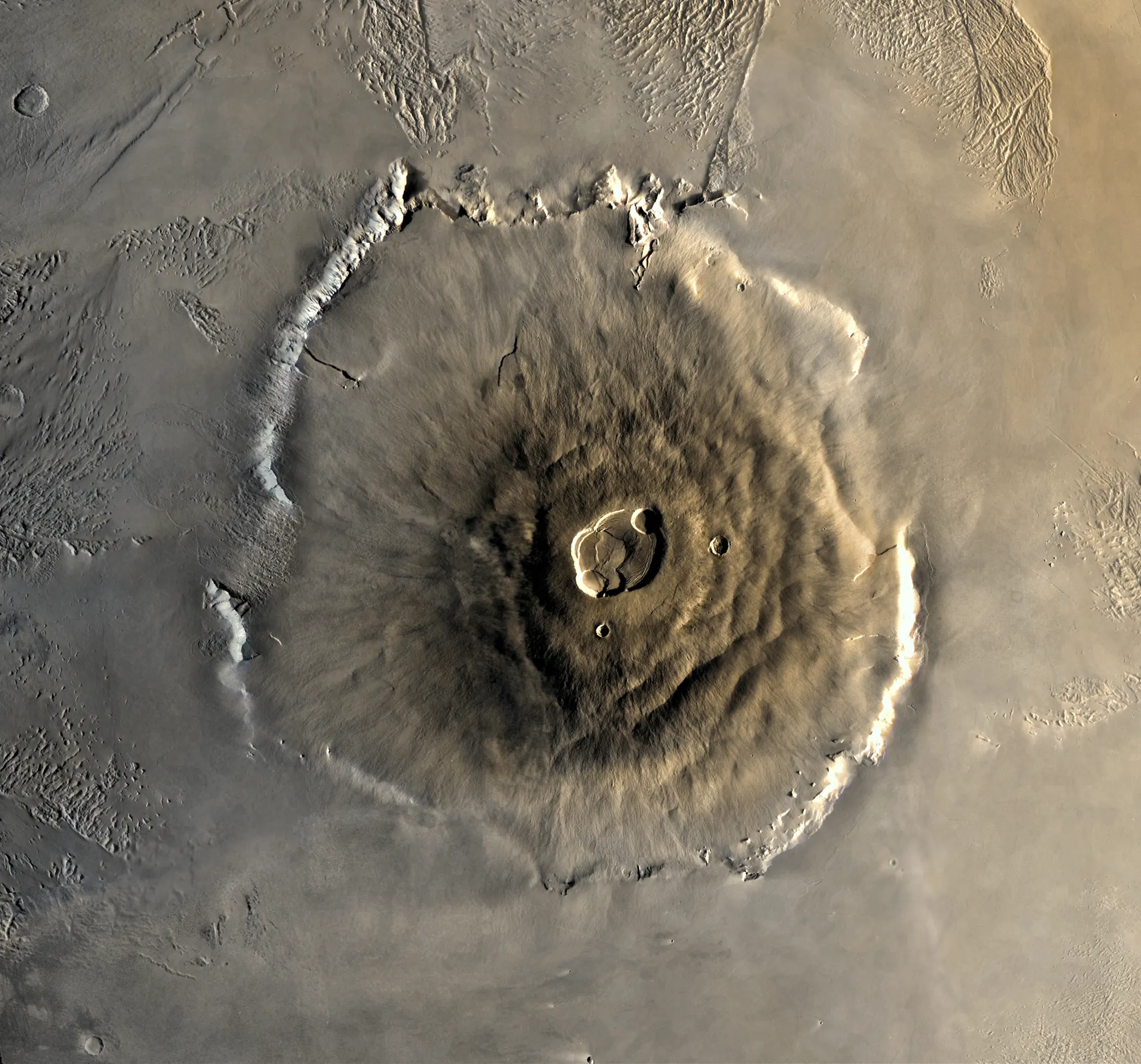 Visible-light mosaic of Olympus Mons from Viking 1, showing the volcano's caldera and flanks in warm ochre tones.